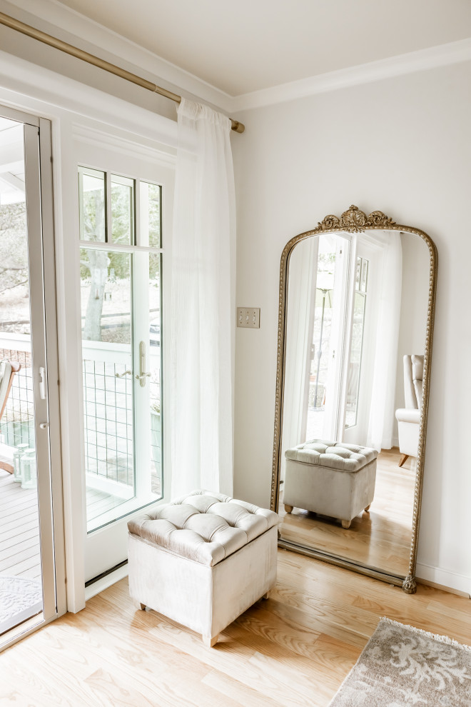 Sitting area with mirror and door to exterior of ADU by Heartwood Residential Design + Build