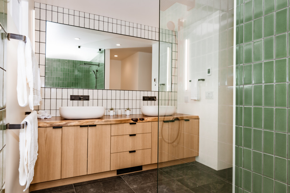 Modern bathroom remodel in the Bay Area with double vanity and green shower tile by Heartwood Residential