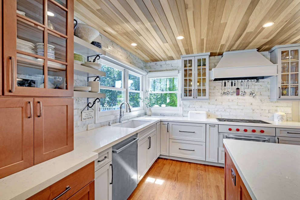 Remodeled Kitchen Featuring White Cabinetry, Silver Appliances, and Windows Above the Sink by Heartwood Residential Design + Build Servicing South Bay Area and Santa Clara County